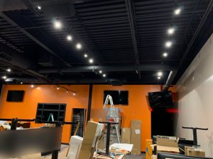 Black Track Lighting Suspended from Black Architectural Ceiling